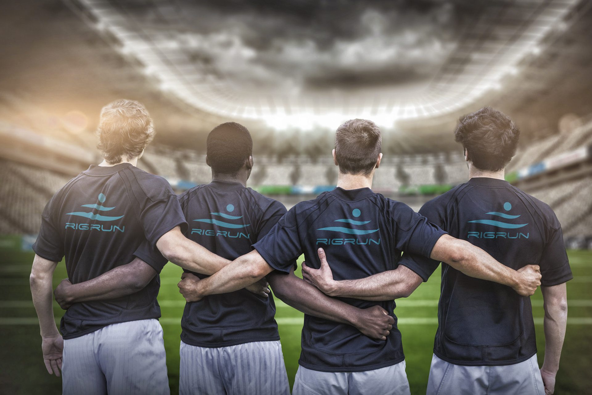 Four men wearing RigRun T-Shirts facing away from the camera toward a stadium